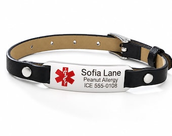 May include: A black leather medical alert bracelet with a silver-toned metal plate. The plate features a red Star of Life symbol and engraved text reading Sofia Lane, Peanut Allergy, and ICE 555-0108, secured with a silver buckle.