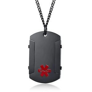 May include: Black dog tag pendant necklace featuring a red medical symbol. The pendant is rectangular with a curved top and a hinged design. The chain is black and of a link style.
