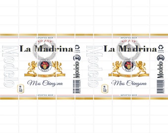 May include: Two 11-ounce cans of Modelo La Madrina beer. The cans are gold and white with a crest featuring a lion and a crown. The text on the cans reads "La Madrina" and "Modelo". One can says "Mas Chingona" and the other says "Mrs Chingona".
