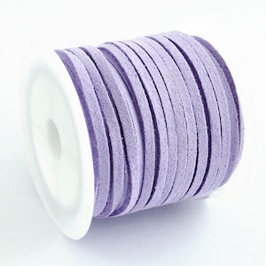May include: A spool of lavender purple suede cord, wound around a white plastic spool.