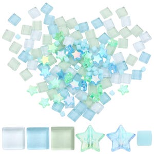 May include: A collection of mosaic tiles and star-shaped embellishments in shades of blue, green, and clear. The square tiles and star shapes are scattered, creating a decorative arrangement. Ideal for craft projects.