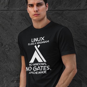May include: A black t-shirt with white text that reads "LINUX is like a WIGWAM NO WINDOWS, NO GATES, APACHE INSIDE". The text is in the shape of a tent.