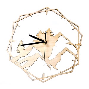 May include: A wooden wall clock featuring a mountain and tree design. The clock has a geometric outer frame and black clock hands. The clock face is natural wood-coloured, and the design is cut out to show the wall behind.