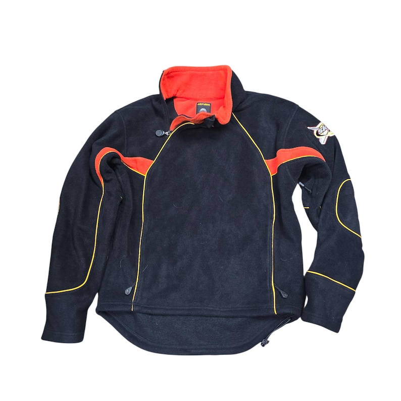 May include: Black fleece jacket with a red collar and orange accents. The jacket features yellow trim, a zipper closure, and a small logo patch on the sleeve. A sporty, warm outerwear garment.