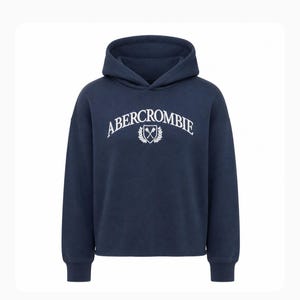 May include: A navy blue long-sleeve hooded sweatshirt featuring the white text ABERCROMBIE arched over a small crest logo with crossed oars and laurel leaves. The garment has a hood, ribbed cuffs, and a straight hemline in a solid dark blue color.