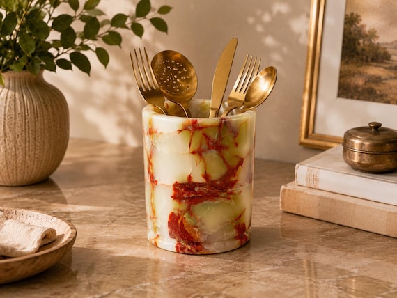 A utensil holder carved from actual natural onyx — each one is a one-of-a-kind geological object that doubles as luxury countertop sculpture.
