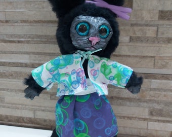 Cool black bunny toy made of fabric and polymer clay.Handmade.A toy for children and adults in clothes with handmade pattern and sneakers.