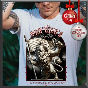 May include: White t-shirt with a detailed lion illustration holding a flag. The design includes the text "THE LION'S Story is Told" and "THE HUNTER IS THE WARRIOR". The shirt has a classic crew neck.