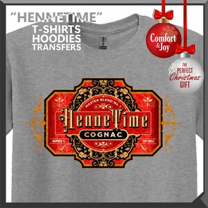 May include: A gray t-shirt with a large, ornate label design featuring the text "HenneTime Cognac." The label is red, black, and gold, with the words "Master Blend No. 1" and "Top Shelf." The shirt also has the text "T-Shirts, Hoodies, Transfers."