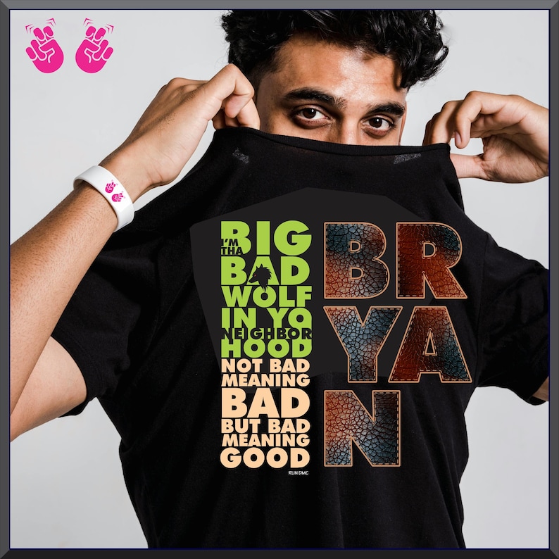 Puede incluir: Camiseta negra con el texto "BIG BAD WOLF IN YO NEIGHBORHOOD" en verde y naranja. El nombre "BRYAN" se muestra en una fuente texturizada. La camiseta tambi&eacute;n incluye el texto "NOT BAD MEANING BAD BUT BAD MEANING GOOD".