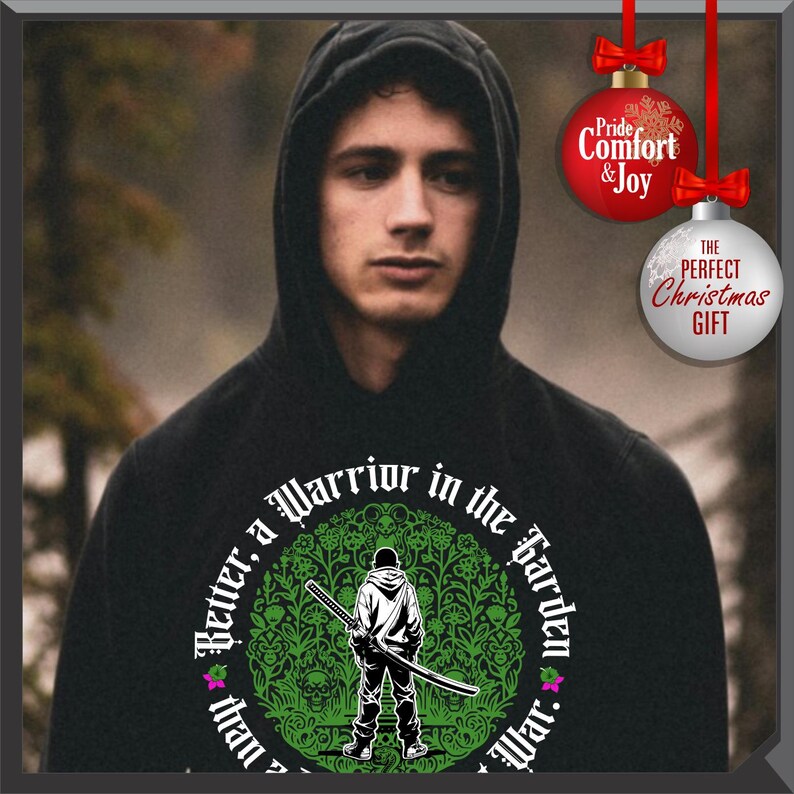 May include: Black hooded sweatshirt with a graphic featuring a warrior holding a sword, surrounded by text that reads "Better, a Warrior in the Garden than War." Christmas ornament decorations are in the background.