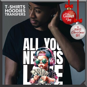 Puede incluir: Camiseta negra con el texto "ALL YOU NEED IS LOVE" y un gr&aacute;fico de un ni&ntilde;o con gafas de sol, auriculares y dinero. La imagen tambi&eacute;n incluye el texto "T-SHIRTS HOODIES TRANSFERS". Tambi&eacute;n se ven adornos navide&ntilde;os con texto.