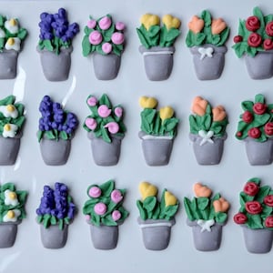 May include: A white ceramic mug with a black handle and the text "But First, Coffee" in a handwritten style. The mug is on a white surface. The mug is approximately 4 inches tall.