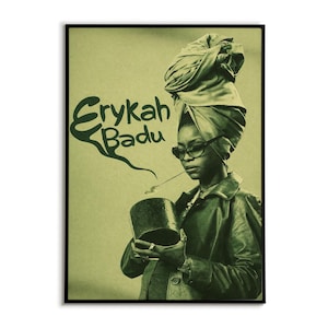 May include: A framed poster with a green-toned image of Erykah Badu. She is depicted wearing a turban, glasses, and a jacket, holding a smoking pipe. The poster features the name "Erykah Badu" in a stylized font.