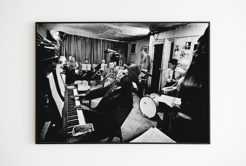 Step into the world of jazz royalty with this captivating poster featuring the legendary Thelonious Monk at the piano, cigar in hand, surrounded by his talented orchestra.