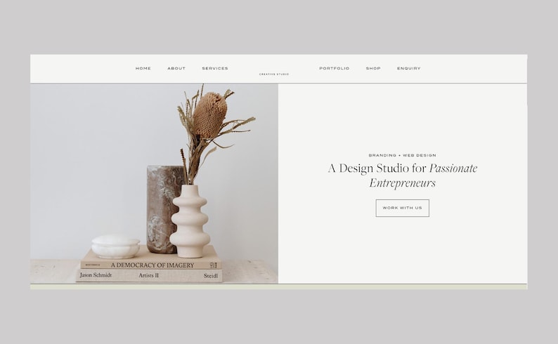 May include: Website design featuring a neutral color palette. A vase with dried flowers sits on a stack of books. The text reads "A Design Studio for Passionate Entrepreneurs."