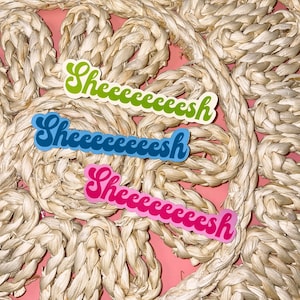 May include: Three stickers with the word "Sheeeeesh" written in a retro font. The stickers are in different colors: green, blue, and pink.
