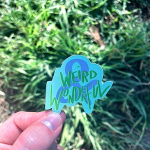 May include: A blue and green sticker with the text "Weird & Wonderful" in a handwritten style.