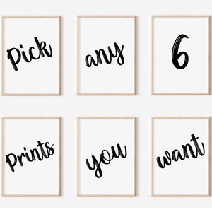 May include: Six framed prints with the words "Pick any 6 Prints you want" in a black, handwritten style font. The prints are displayed on a white background with light brown frames.