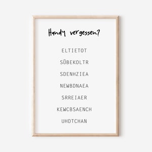 May include: A framed print with the text "Handy vergessen?" and a list of scrambled words: ELTIETOT, S&Uuml;BEKOLTR, SDENHZIEA, NEWBDNAEA, SRREIAER, KEWCBSAENCH, UHDTCHAN.