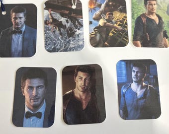 Juego de marcapáginas laminados de Nathan Drake con o sin borla – Paquete de 3, 5 o 7 unidades / GeekyBookmarks