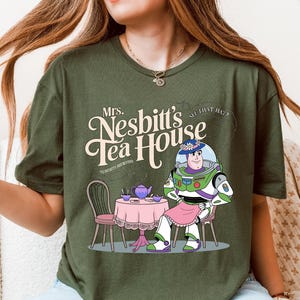 a woman sitting on a couch wearing a tee shirt