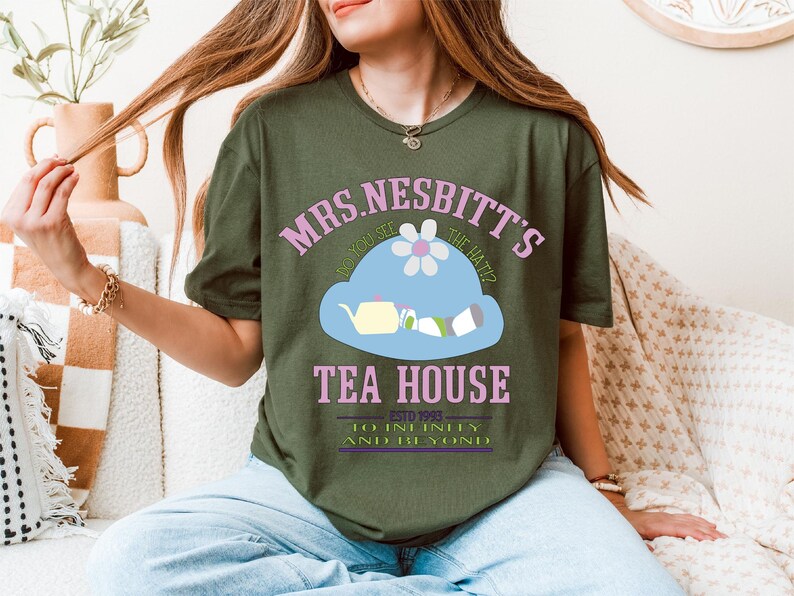 a woman sitting on a couch wearing a green shirt