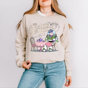 a woman wearing a sweatshirt with a cartoon character on it