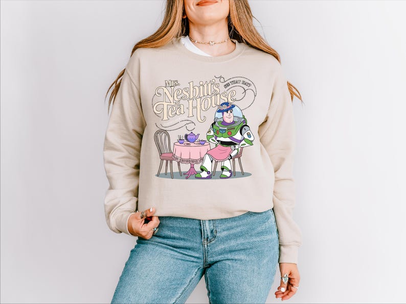 a woman wearing a sweatshirt with a cartoon character on it