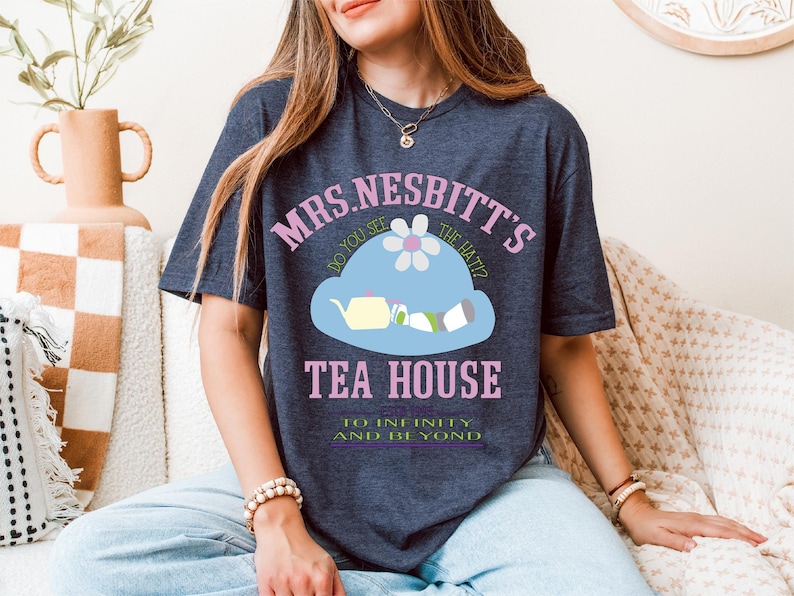 a woman sitting on a couch wearing a blue shirt