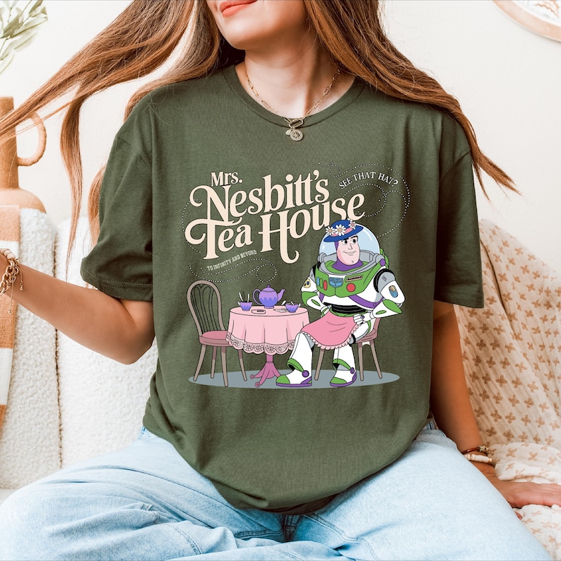 a woman sitting on a couch wearing a tee shirt