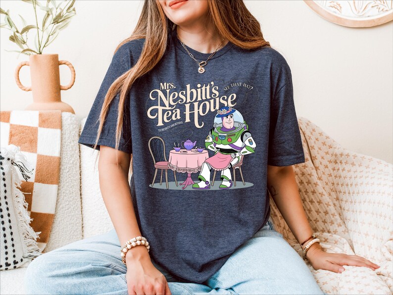 a woman sitting on a couch wearing a t - shirt