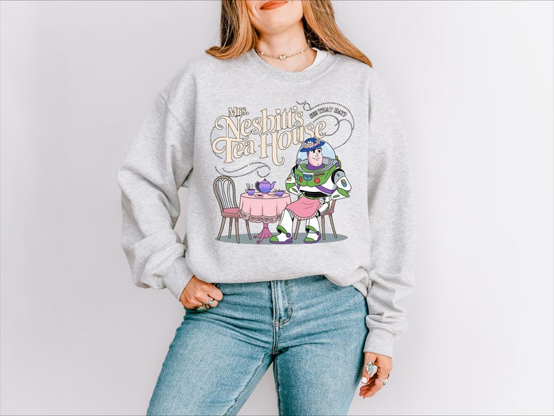 a woman wearing a sweatshirt with a cartoon character on it