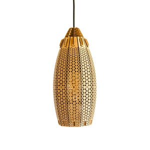 May include: A gold-colored, perforated pendant light fixture. The light has a cylindrical shape with a textured surface and a series of small, evenly spaced holes. The top of the light fixture has a geometric design. The light hangs from a black cord.