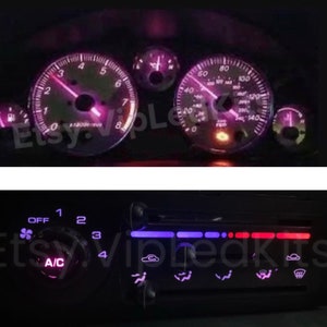 May include: A car dashboard with a purple and white gauge cluster and a purple and white climate control panel. The gauge cluster includes a speedometer, tachometer, and fuel gauge. The climate control panel includes a fan speed knob, temperature control knobs, and buttons for air conditioning, defrost, and rear window defroster.