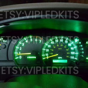 May include: Green LED gauge cluster with a speedometer, tachometer, and other gauges. The gauges are illuminated in green. The text "ETSY:VIPLEDKITS" is visible on the image.