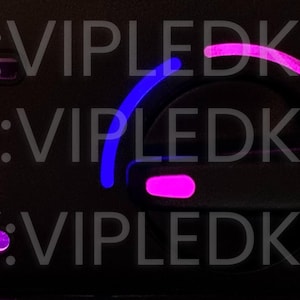 May include: A close-up of a car's dashboard with pink and blue LED lights illuminating the buttons and controls. The text "ETSY:VIPLEDKITS" is visible on the dashboard.