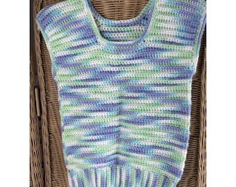May include: A sleeveless crochet top in a mix of blue, green, and white yarn. The top has a scoop neck and a ribbed hem. The yarn is a variegated color, creating a striped pattern. The top is hanging on a white hanger.