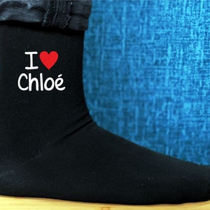 May include: Black socks with a white heart and the text "I love Chloe" printed on them.