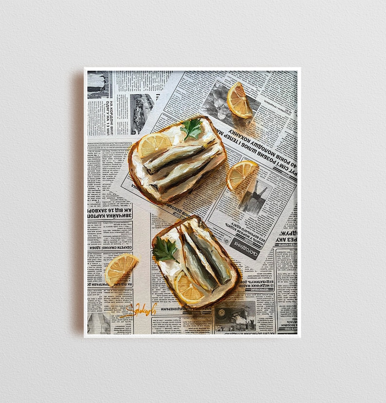 May include: Two open-faced sandwiches with white bread, cream cheese, and sardines on a newspaper background. The sandwiches are topped with parsley and lemon slices.