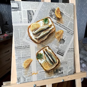 May include: A painting of two open-faced sandwiches with sardines, lemon slices, and parsley on a newspaper background.