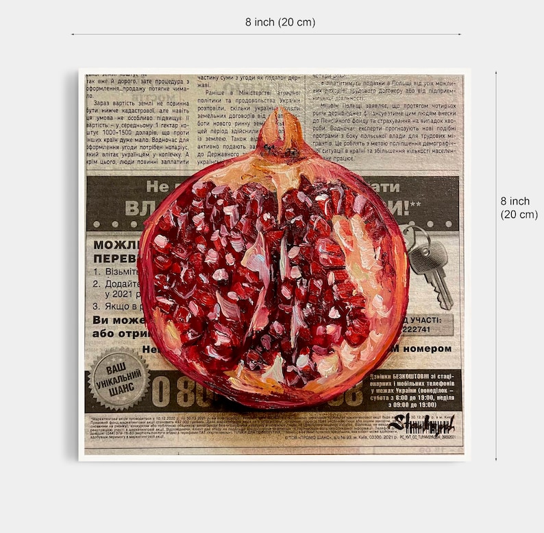 May include: A close-up of a painting of a halved pomegranate with red seeds and a white background. The painting is on top of a newspaper with text in a foreign language. The text includes the words "можливі переваги" and "Ваш унікальний шанс".