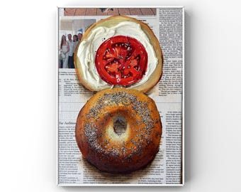 May include: A framed print of a bagel with cream cheese and a tomato slice, and a poppy seed bagel. The bagels are on a newspaper background. The top bagel is open-faced with a red tomato slice.