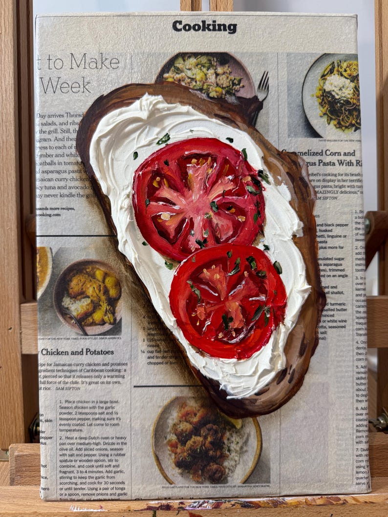 May include: A painting of a slice of toasted bread topped with white cream cheese and two red tomato slices. The painting is on a canvas with a newspaper clipping visible in the background. The newspaper clipping is about cooking and features a recipe for chicken and potatoes.