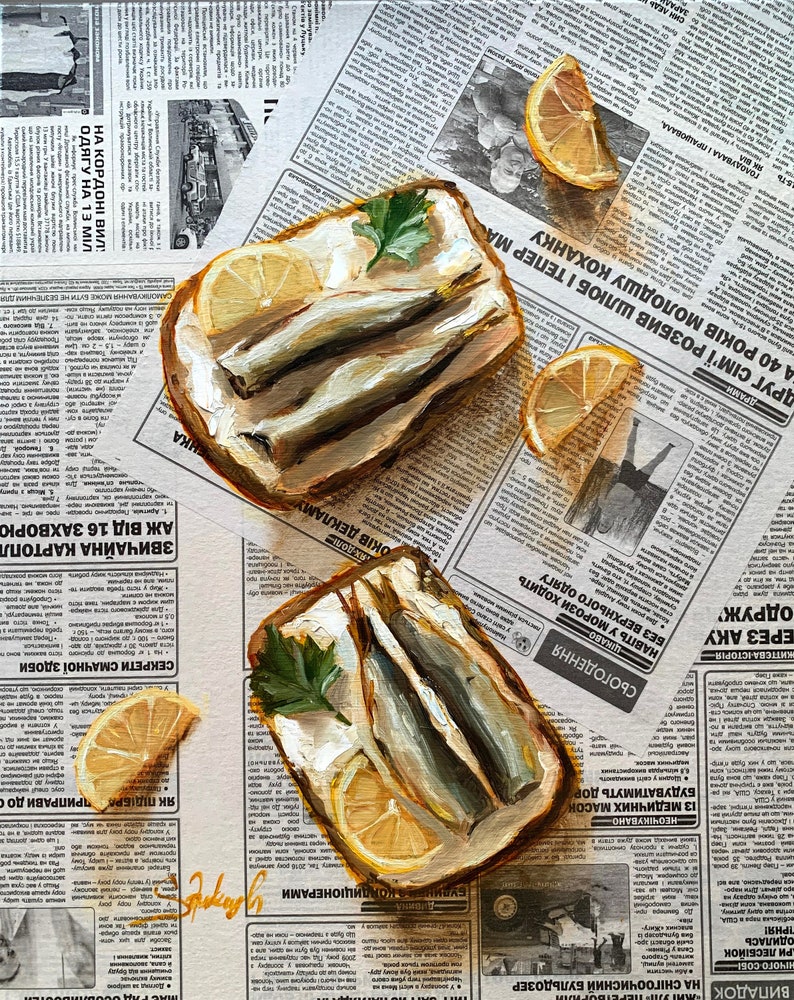 May include: Two open-faced sandwiches with sardines, lemon slices, and parsley on a newspaper background.
