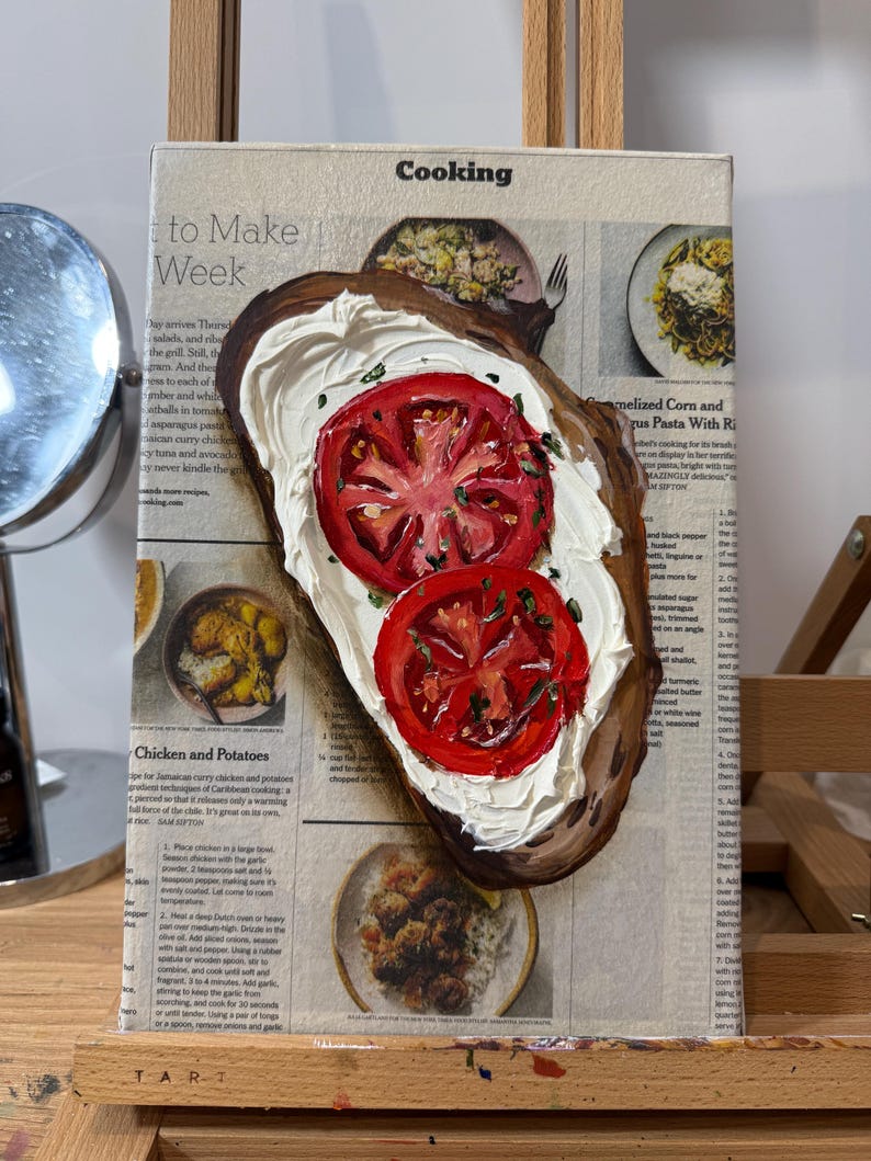 May include: A painting of a slice of bread topped with white cream cheese and two red tomato slices. The painting is on a canvas with a newspaper background. The newspaper text includes the words "Cooking", "to Make", "Week", "Chicken and Potatoes", and "melized Corn and zus Pasta With Ri".