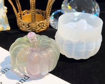 May include: A clear, iridescent pumpkin-shaped resin mold with a textured surface. The mold is made of silicone and is designed for crafting.