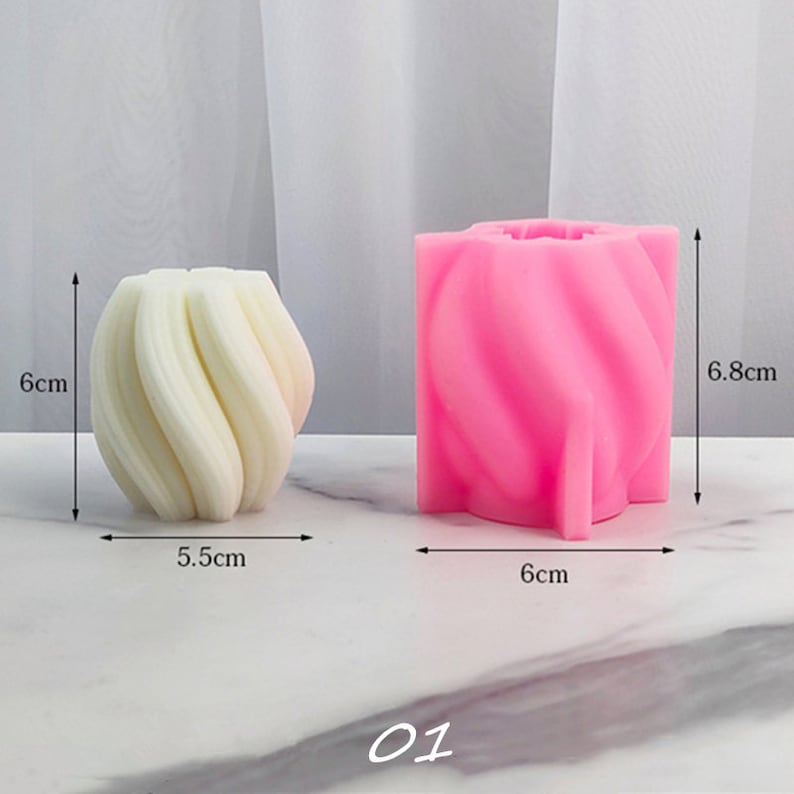 May include: Two silicone molds for making candles. The mold on the left is white and the mold on the right is pink. Both molds are shaped like a swirl. The white mold measures 5.5 cm in diameter and 6 cm in height. The pink mold measures 6 cm in diameter and 6.8 cm in height. The image is labeled "01".