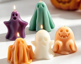 May include: A collection of Halloween-themed ghost candles in various colors, including purple, green, orange, and white. Each candle is shaped like a friendly ghost with a lit wick, creating a festive and spooky atmosphere. A carved pumpkin is in the background.