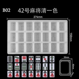 May include: A white silicone mould for making mahjong tiles. The mould has 18 individual squares, each with a different mahjong tile design. The mould measures 27.4 cm by 15 cm. The image also shows a set of 18 mahjong tiles.